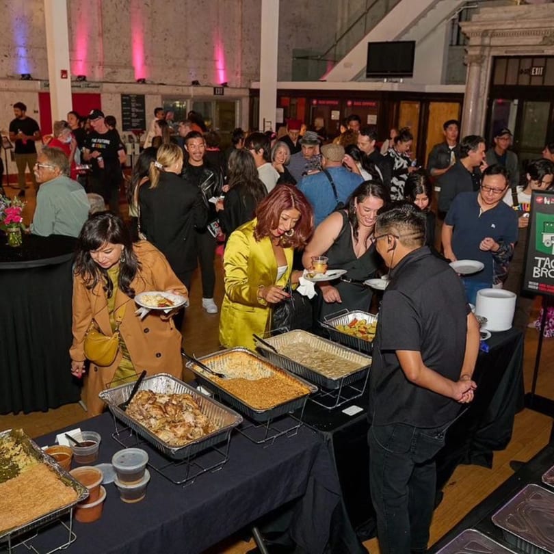 Guests at The Park's Finest buffet, serving themselves Filipino dishes from chafing dishes.