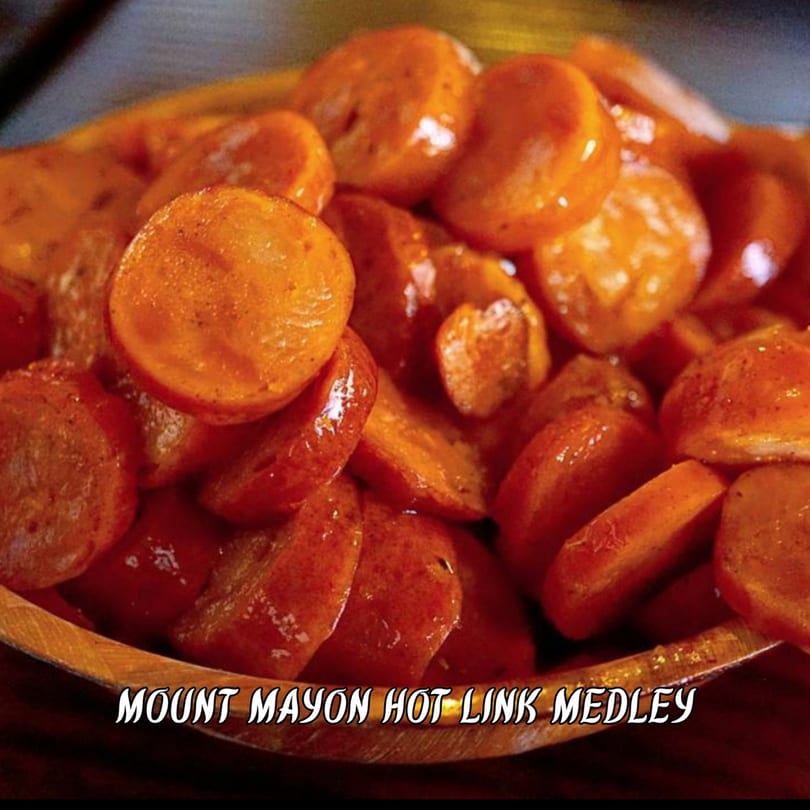 Close-up of Mount Mayon Hot Link Medley, featuring glistening, sliced hot links in a wooden bowl.