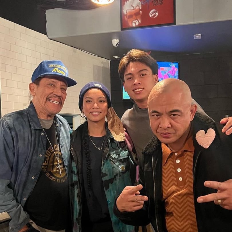 Danny Trejo and three other people smiling for a photo inside The Park's Finest.