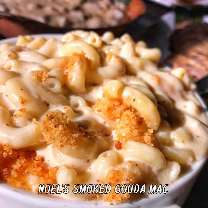 Close-up of creamy mac and cheese with elbow pasta and crispy breadcrumbs in a white bowl.