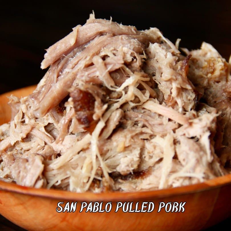 Close-up of San Pablo Pulled Pork in a wooden bowl, showcasing its tender, shredded texture.